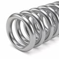 A silver cylindrical metal spring with flat ends, isolated on a white Royalty Free Stock Photo