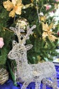 Silver deer near decorated Christmas tree Royalty Free Stock Photo