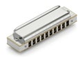 A silver diatonic harmonica on a white background Royalty Free Stock Photo