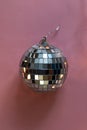 Silver disco ball on pink  background, greeting card wallpaper template with empty space for text Royalty Free Stock Photo