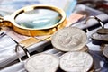 Silver dollar and numismatic coins with magnifying glass Royalty Free Stock Photo