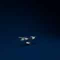 Silver Drone flying with action video camera icon isolated on blue background. Quadrocopter with video and photo camera