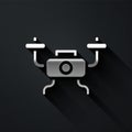 Silver Drone flying icon isolated on black background. Quadrocopter with video and photo camera symbol. Long shadow