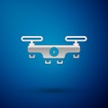 Silver Drone flying icon isolated on blue background. Quadrocopter with video and photo camera symbol. Vector Royalty Free Stock Photo