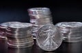 A silver Eagle coin in front of stacks of silver eagle coins Royalty Free Stock Photo