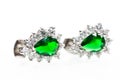 Silver earrings with green emerald stones close up macro shot Royalty Free Stock Photo