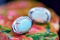 Silver earrings with white opal stone close-up Royalty Free Stock Photo