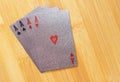 Silver embossed playing cards on the bamboo background.