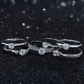 Silver engagement rings with diamonds on black background with bokeh Royalty Free Stock Photo