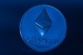 silver ether coin from ethereum on black large view on blue light