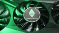 Silver Ethereum coin lies on a black video card iilluminated by green light . Crypto currency