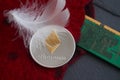 Silver Ethereum coin lying on the red wool