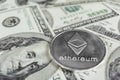 Silver Ethereum on hundred dollars bills. Close-up, macro shot.