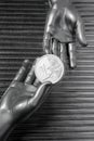 Silver euro coins in futuristic robot hands