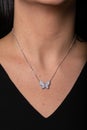 Silver female chain with a pendant in the shape of a butterfly hanging around his neck. Royalty Free Stock Photo