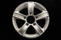 Silver five-spoke alloy wheels rim for a crossover or SUV on a black background Royalty Free Stock Photo