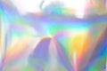 the silver foil surface reflecting the colorful rainbow holographic background. Royalty Free Stock Photo