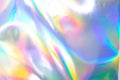 the silver foil surface reflecting the colorful rainbow holographic background. Royalty Free Stock Photo