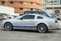 Silver Ford Mustang stands on the city parking