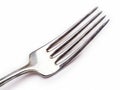 A silver fork with four tines on a white background Royalty Free Stock Photo