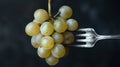 Silver fork holding fresh white grapes against dark background Royalty Free Stock Photo
