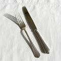 The silverware\'s smooth, reflective surface contrasts the soft Royalty Free Stock Photo