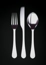 Silver fork, knife and spoon on black background with copy space Royalty Free Stock Photo