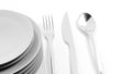 Silver fork, spoon and knife with a stack of plates Royalty Free Stock Photo