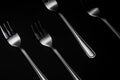 Silver Forks in Row on Dark Background. Low Kay Noir Image. Still Life Pattern Background