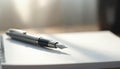 Silver fountain pen rests on white blank notepad page, ready for use. Clean desk surface with soft light, focus on writing tool. Royalty Free Stock Photo