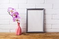 Silver frame mockup with orchid in pink twisted vase