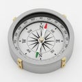 Silver-framed compass with a round design. Royalty Free Stock Photo
