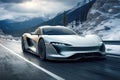 A silver futuristic sports car speeding on the snowy mountains road