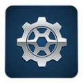 Silver gear icon on a dark blue square background with rounded corners. The gear has Royalty Free Stock Photo