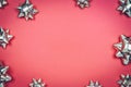Silver gift bows on the red background with place for text Royalty Free Stock Photo