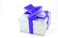 Silver gift box with blue bow isolated on white Royalty Free Stock Photo