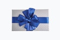 Silver Gift box with blue ribbon bow isolated on white background Royalty Free Stock Photo