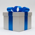 Silver gift box with blue satin bow ribbon on white background Royalty Free Stock Photo