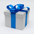 Silver gift box with blue satin bow ribbon on white background Royalty Free Stock Photo