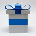 Silver gift box with blue satin bow ribbon on white background Royalty Free Stock Photo