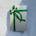 Silver gift box with green ribbon ideas for Christmas, birthday, and gift for your special one Royalty Free Stock Photo