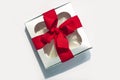 Silver gift box with red ribbon bow isolated on white background. Copy space, flatlay, top view Royalty Free Stock Photo