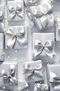 Silver gift group with ribbons on silver background.