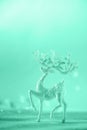 Silver glitter Christmas deer on neon blue background with lights bokeh, copy space. Greeting card for new year party. Festive Royalty Free Stock Photo