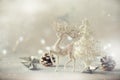 Silver glitter Christmas tree, deer, cones on grey background with lights bokeh, copy space. Greeting card for new year party. Royalty Free Stock Photo