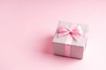 Silver glitter gift box with pink ribbon bow on pink background. Christmas, Valentine's day or birthday concept. Royalty Free Stock Photo