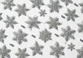 Silver glitter snowflake decorations are arranged against a white Royalty Free Stock Photo