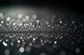 Silver glitter sparkles on dark background. Shimmering particles create elegant look. Abstract design for various uses. Ideal for Royalty Free Stock Photo