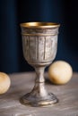 a silver goblet with gold rim