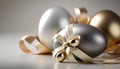 Silver and gold easter eggs with ribbon and bow on grey background Royalty Free Stock Photo